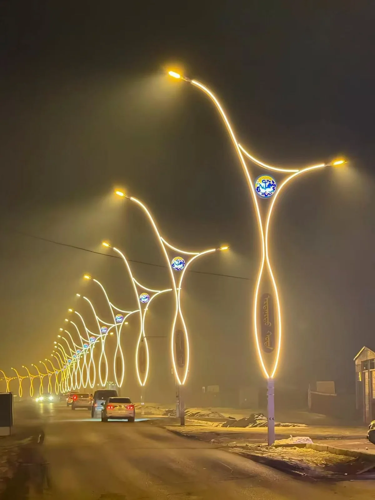 Decorative street lighting along a road at night